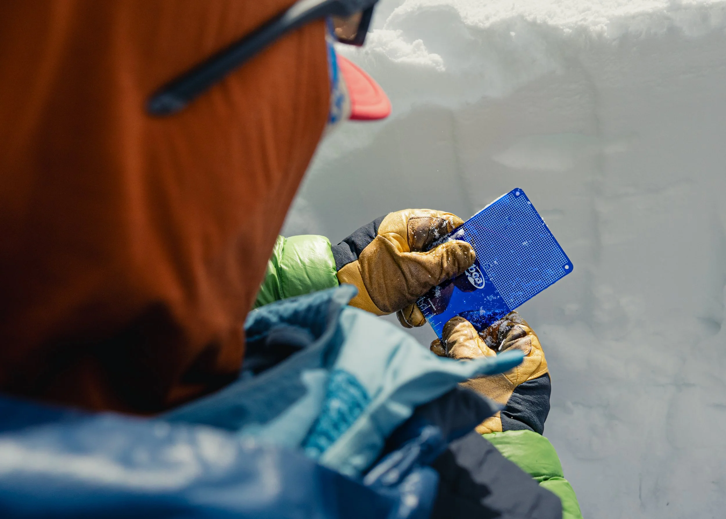 BCA Snow ruler in the hands of ski gloves