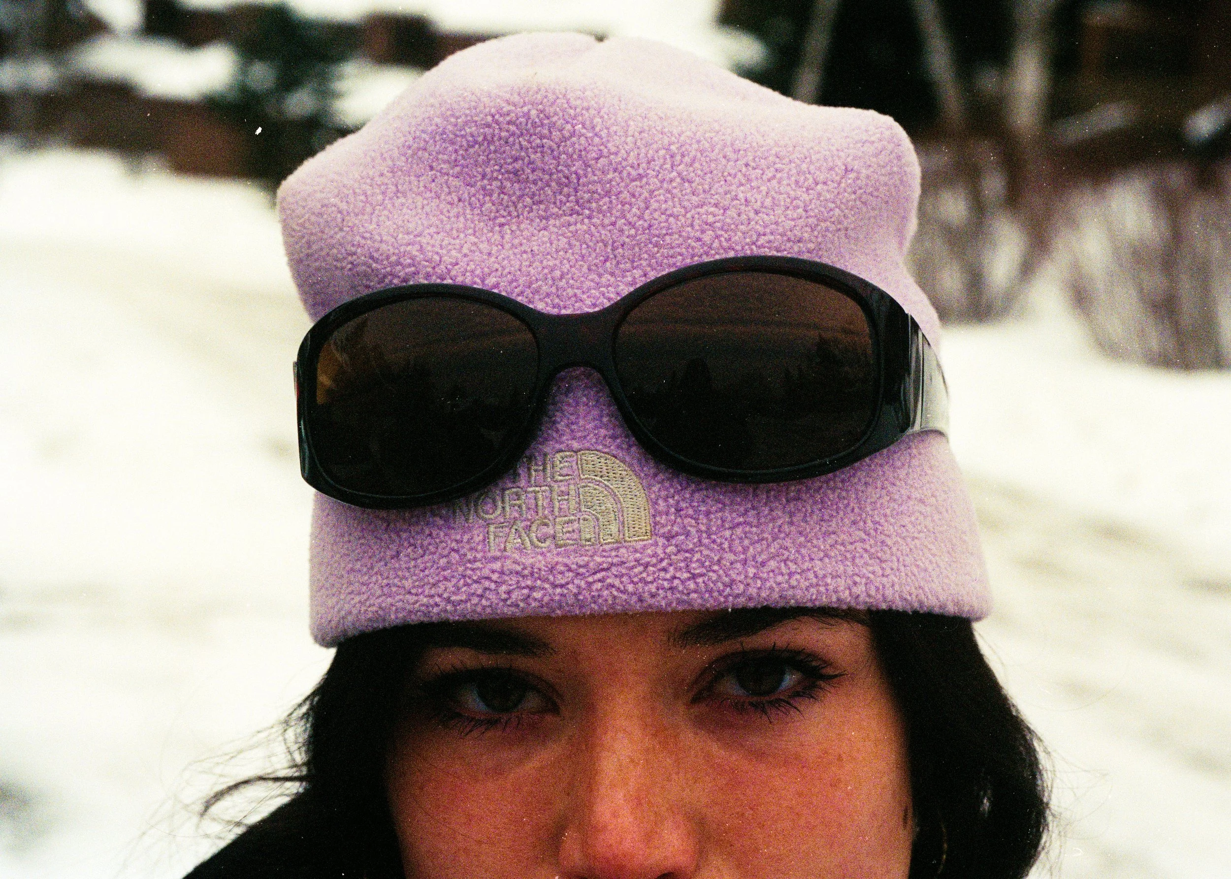 35mm Film Photo of woman with glasses on pink north face beanie