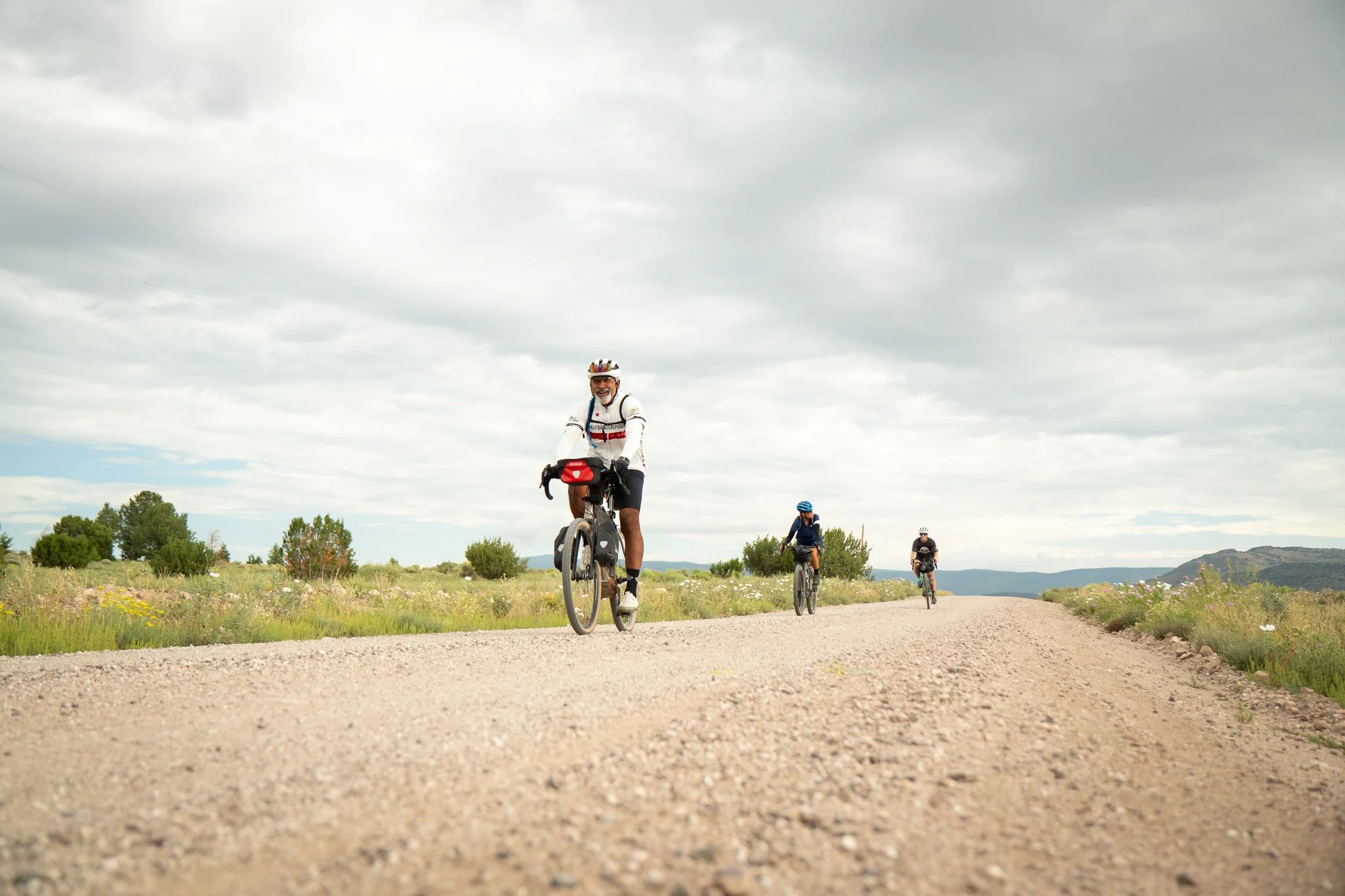Gravel bikers on long, straight road in New Mexico