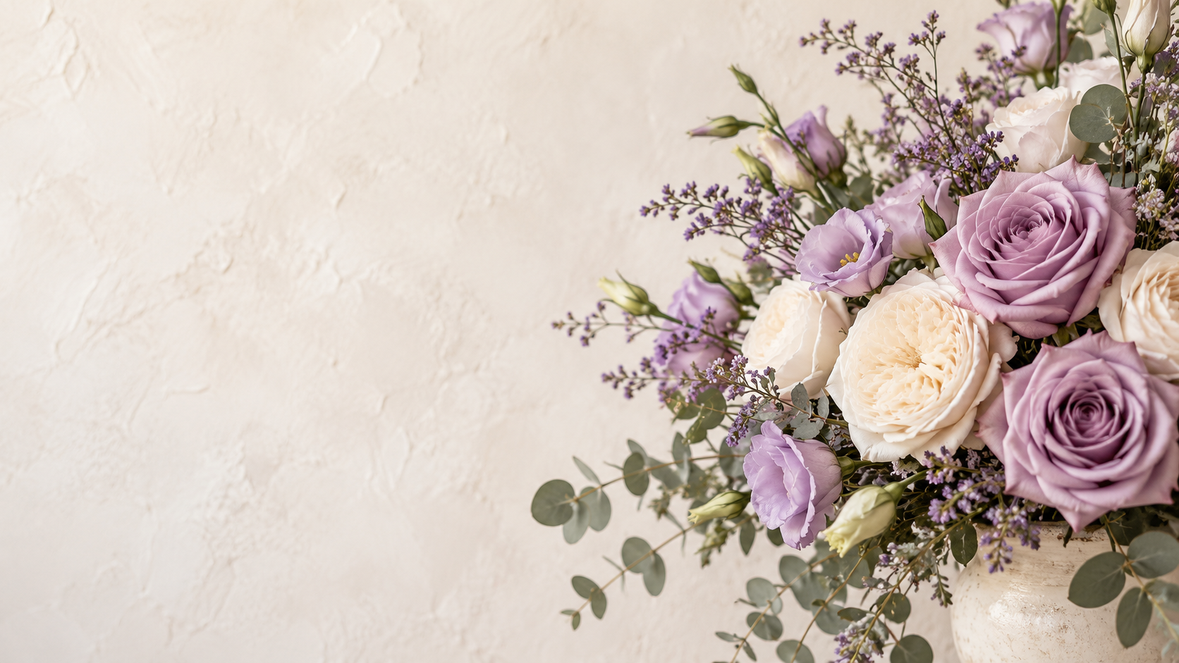 Lavender and ivory flowers with eucalyptus in a ceramic vase