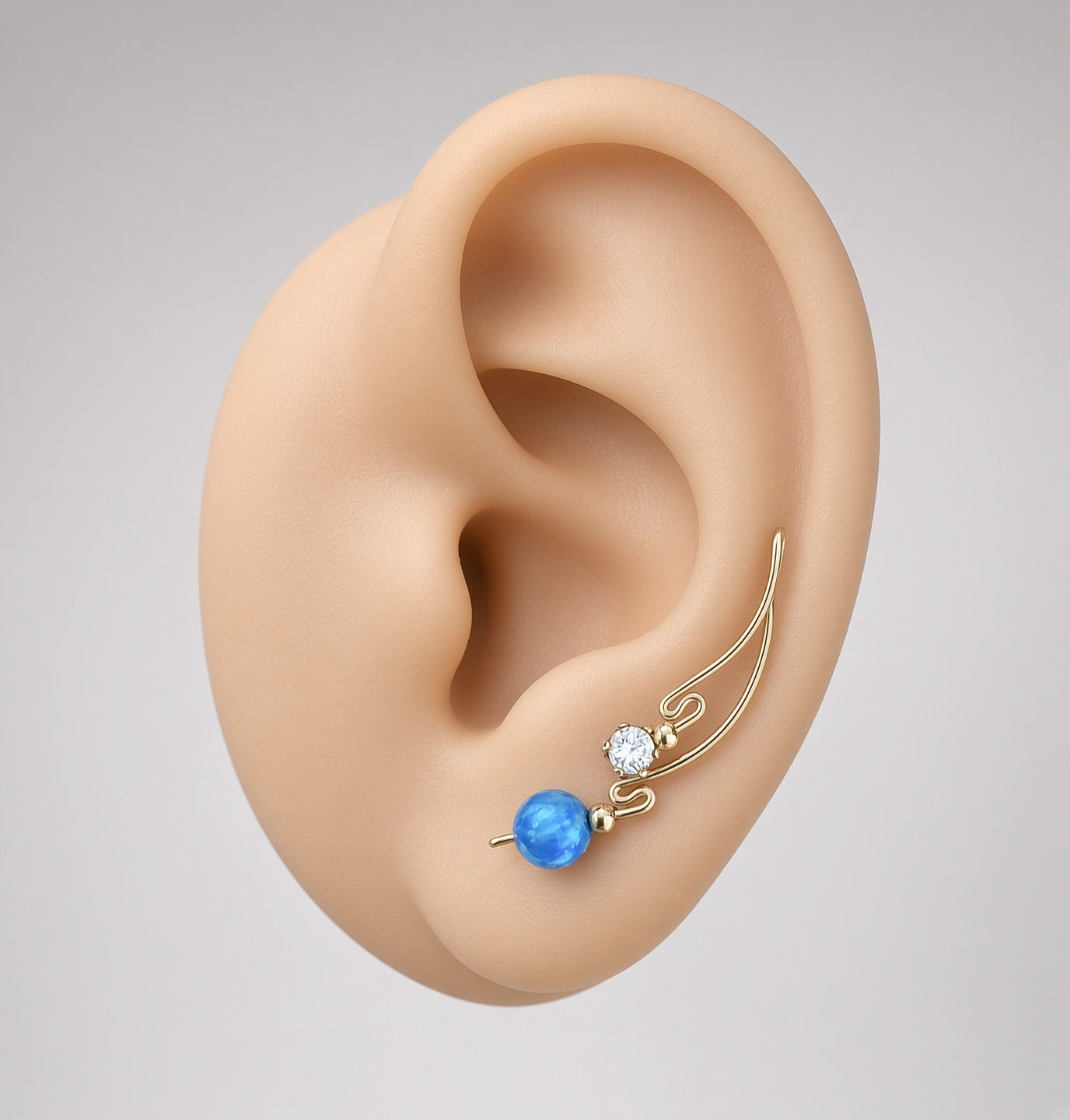 Close-up of a realistic ear wearing a gold ear climber earring with blue and clear gemstones