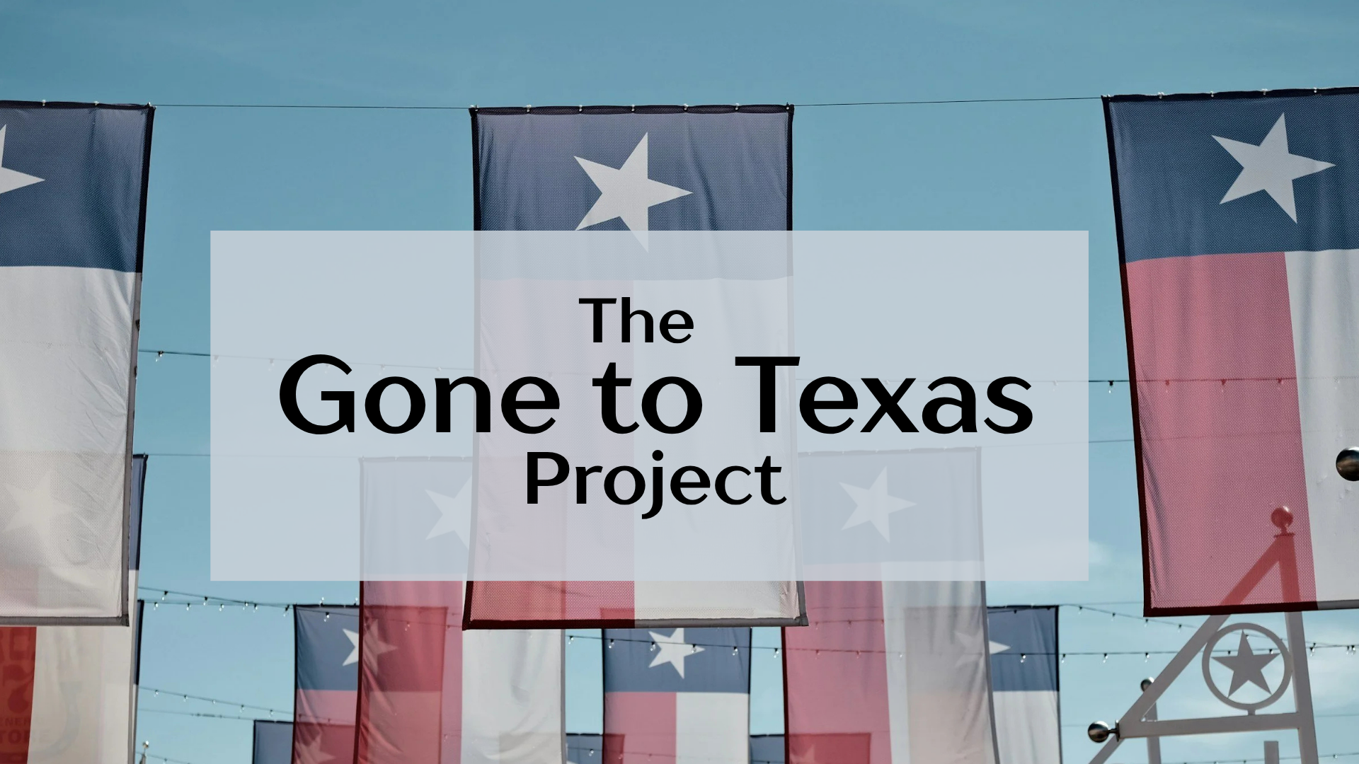 Texas flags hanging outdoors with overlay text reading “The Gone to Texas Project.”