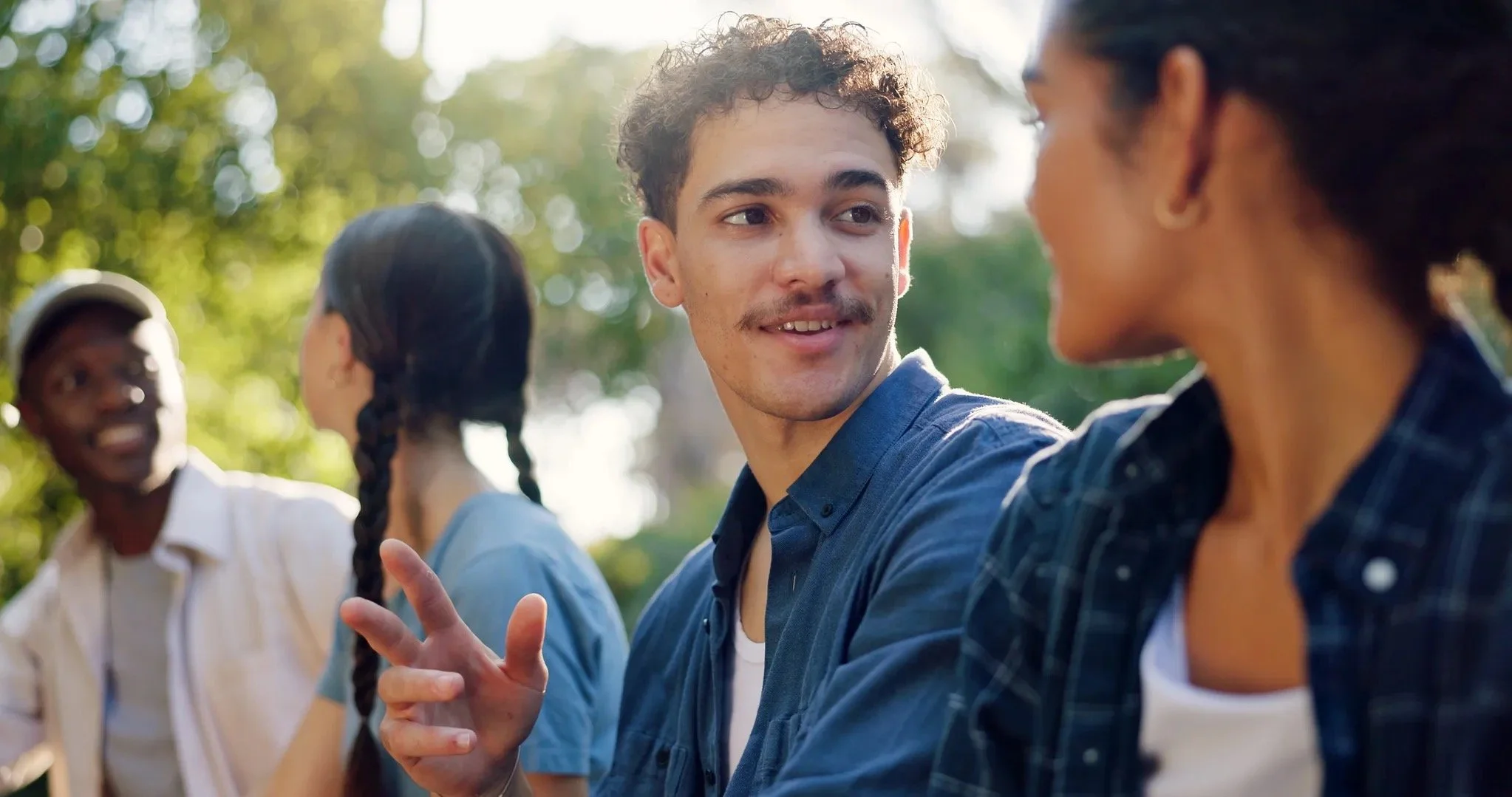 Young adults talking together outdoors