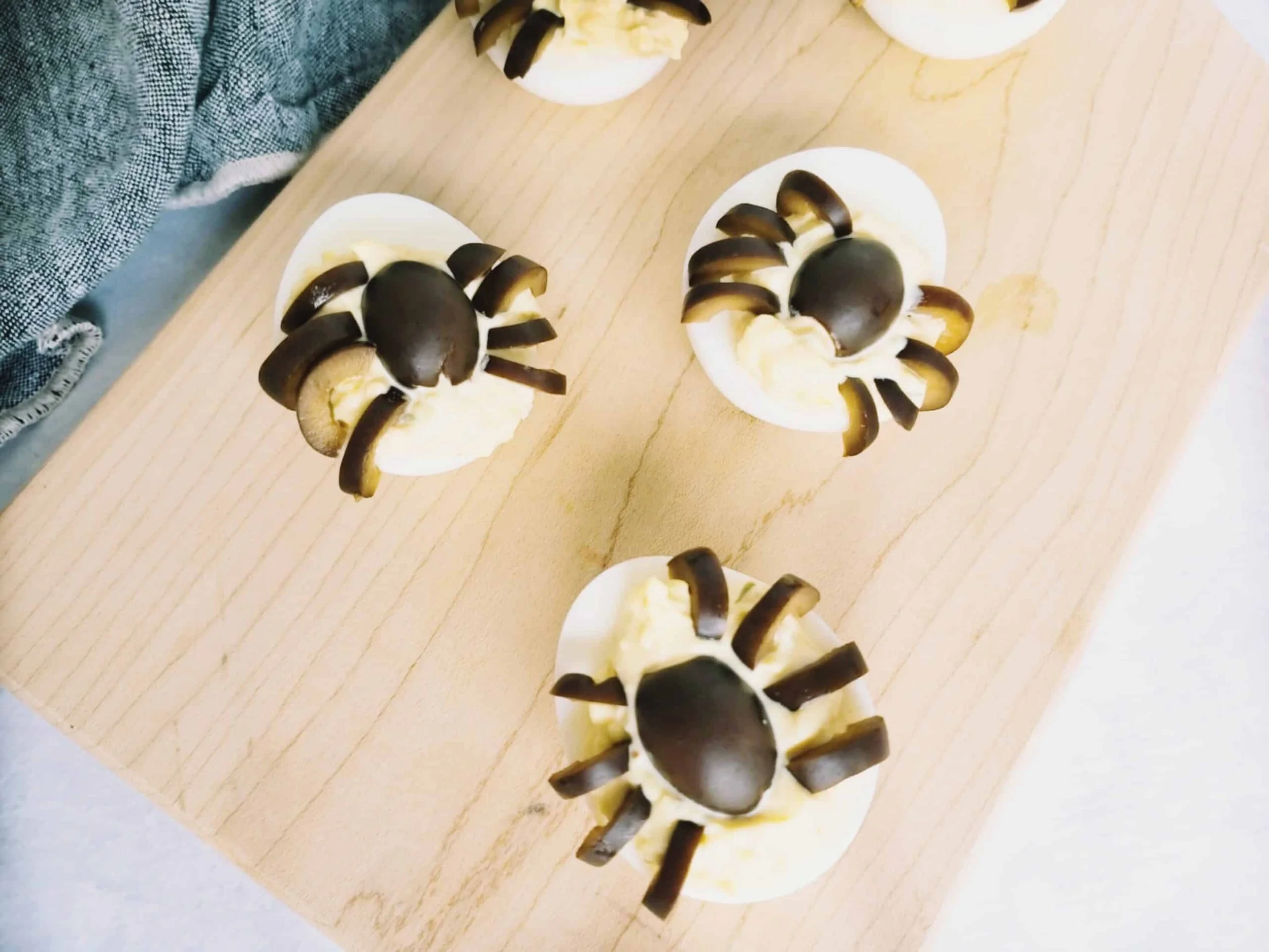 Deviled eggs with sides made of black olives