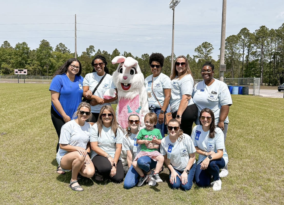 Junior Auxiliary members with kids at an outdoor community event