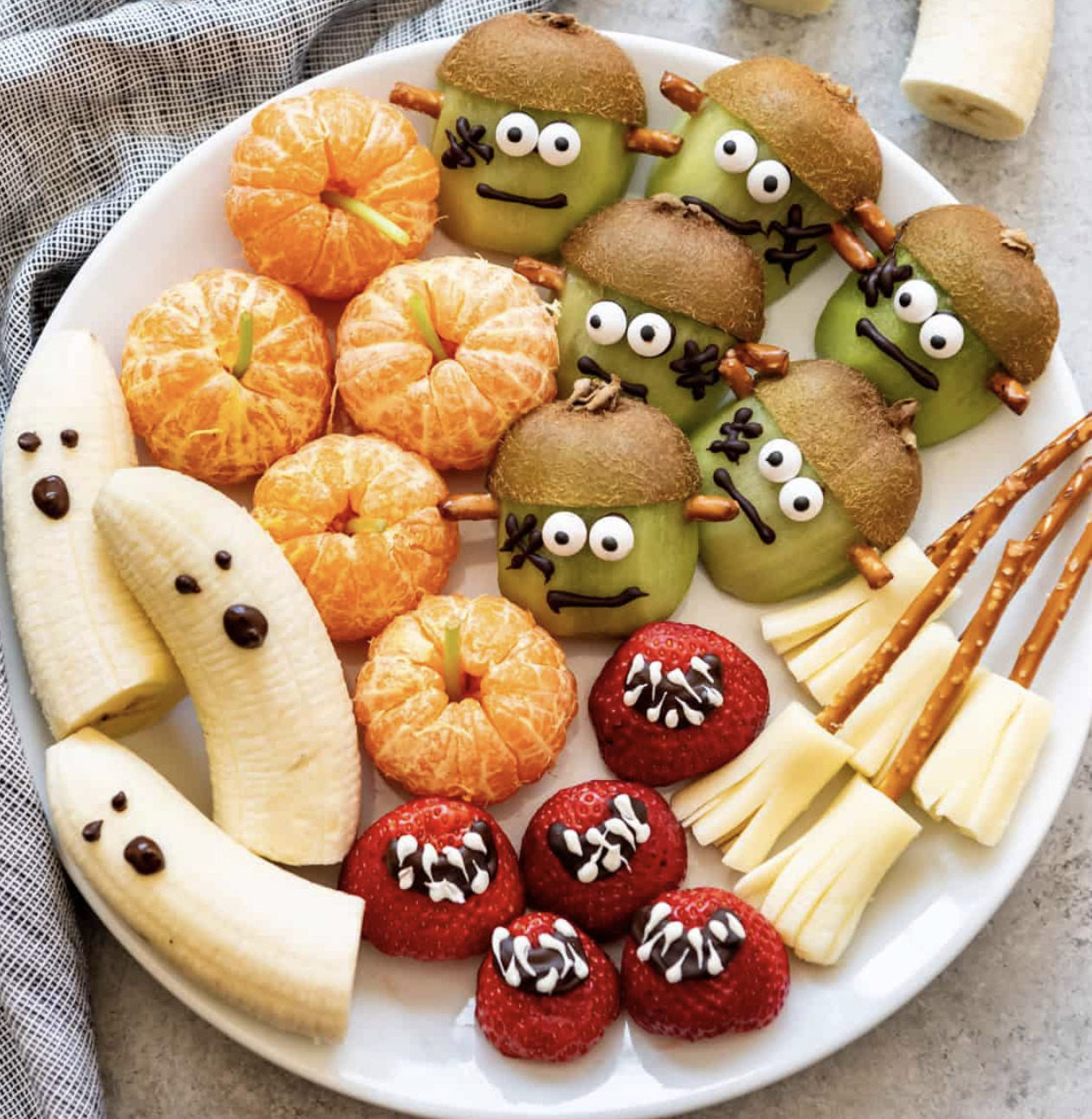 Halloween fruit platter with banana ghosts and orange pumpkins