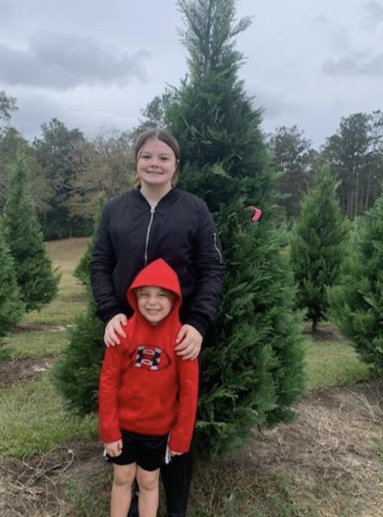 Siblings at a Christmas tree farm