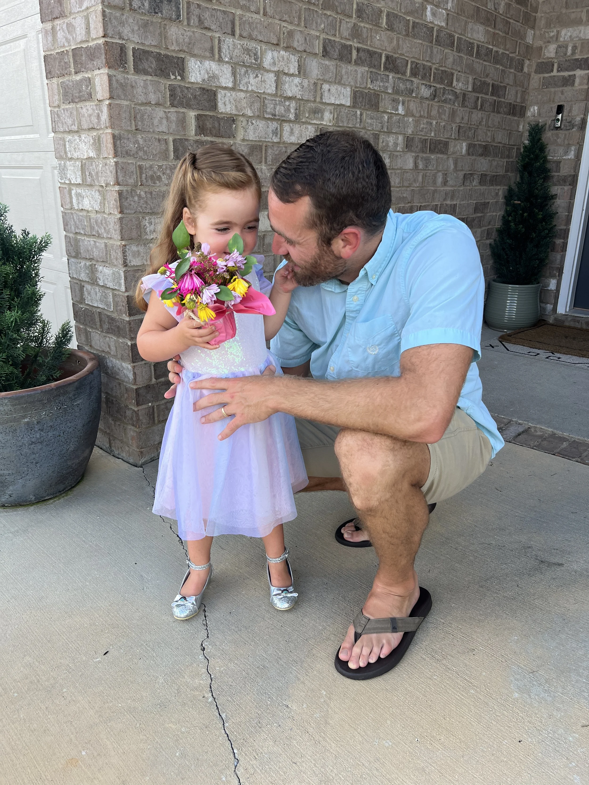 Dad giving his daughter flowers before their date
