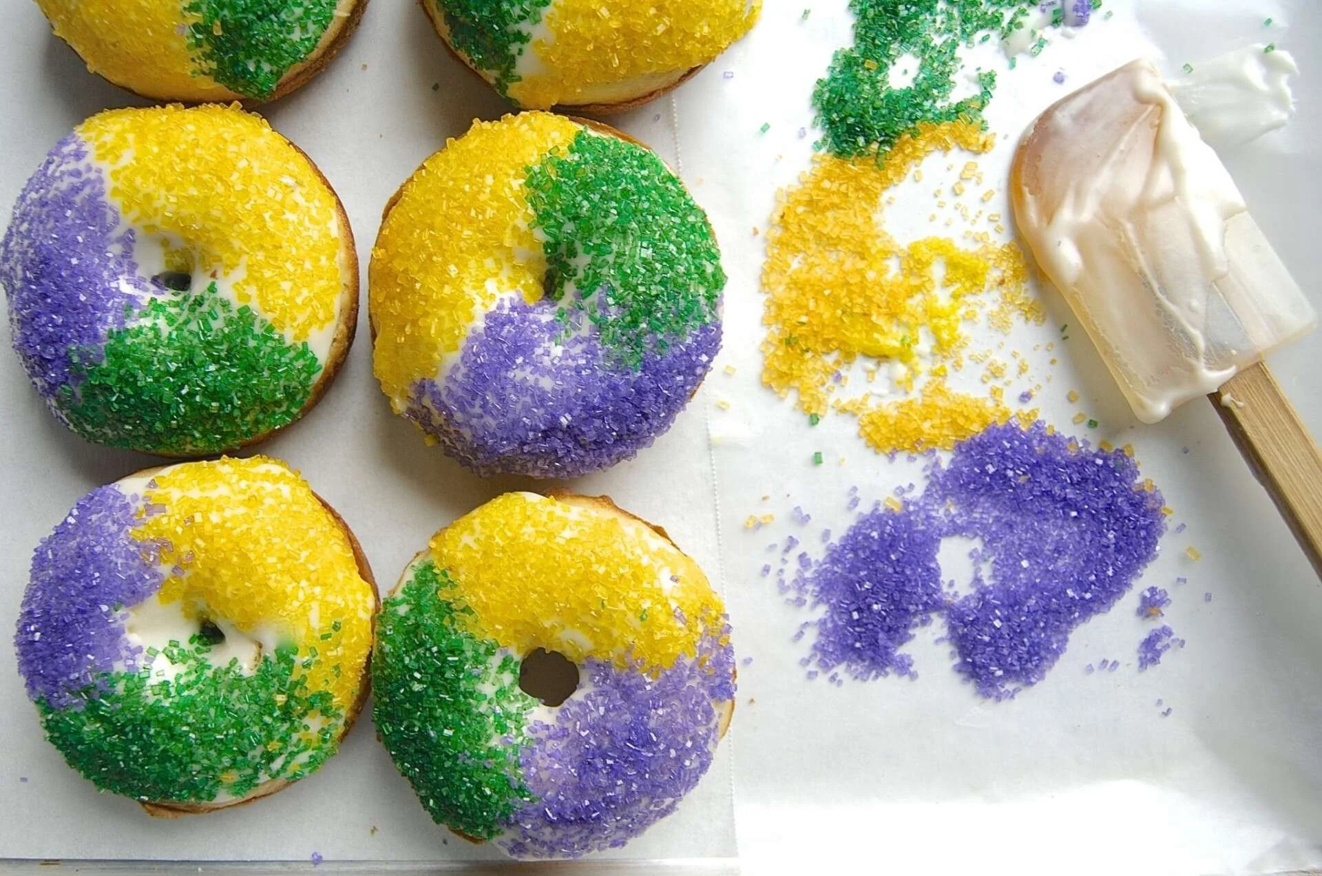 King cake donuts with purple, green and gold sugar