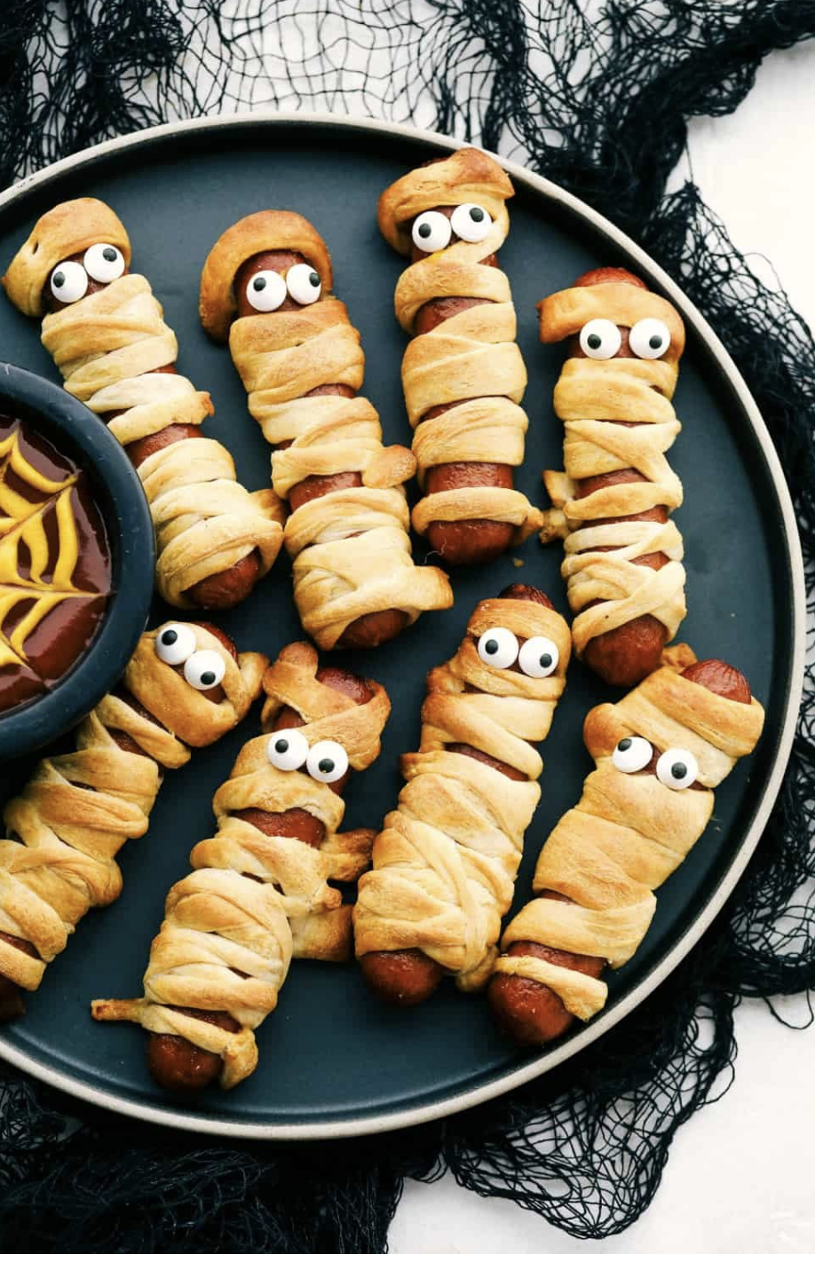 Mummy hot dogs wrapped in crescent dough with candy eyes