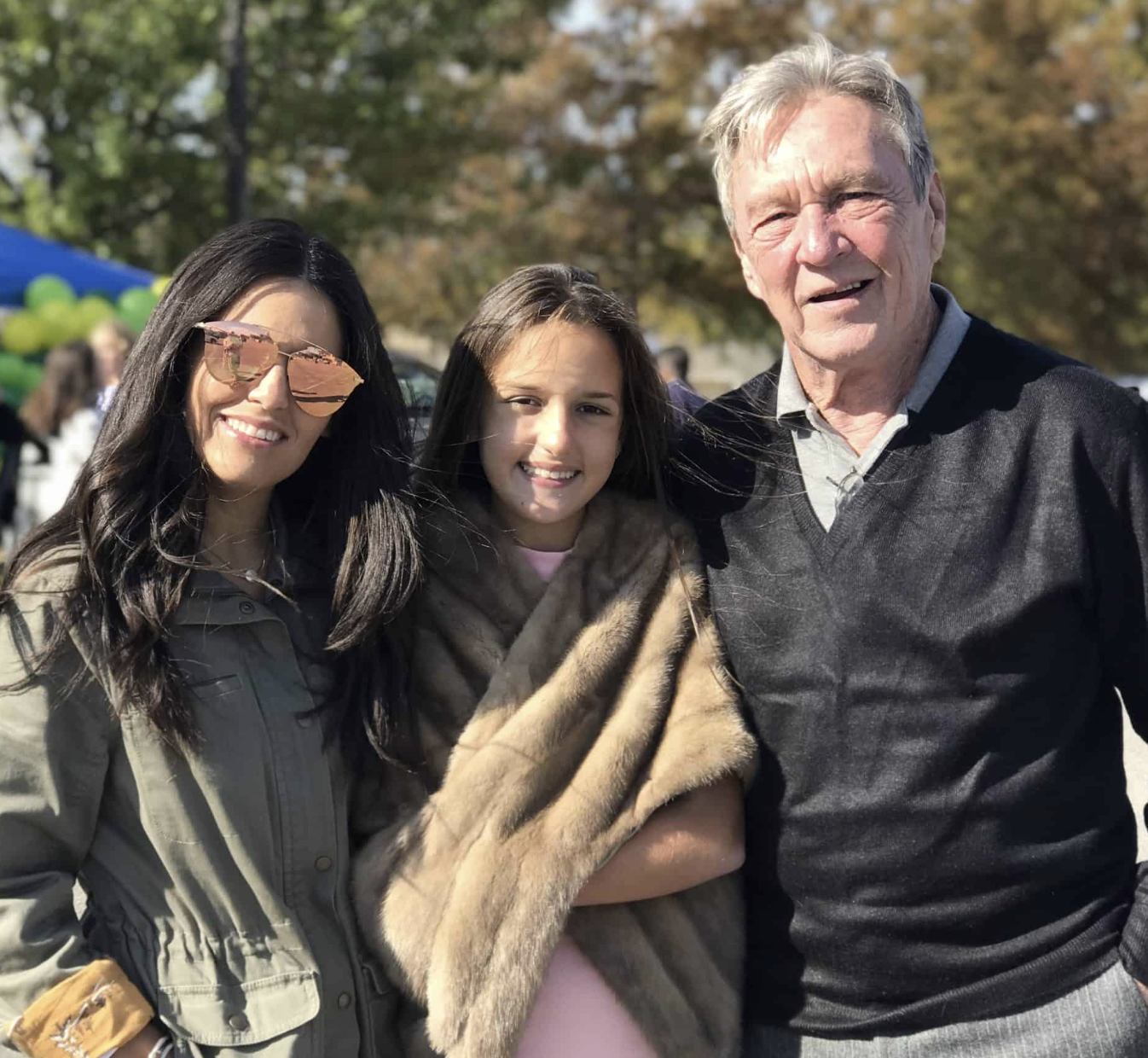 Teen with her mom and grandfather outdoors