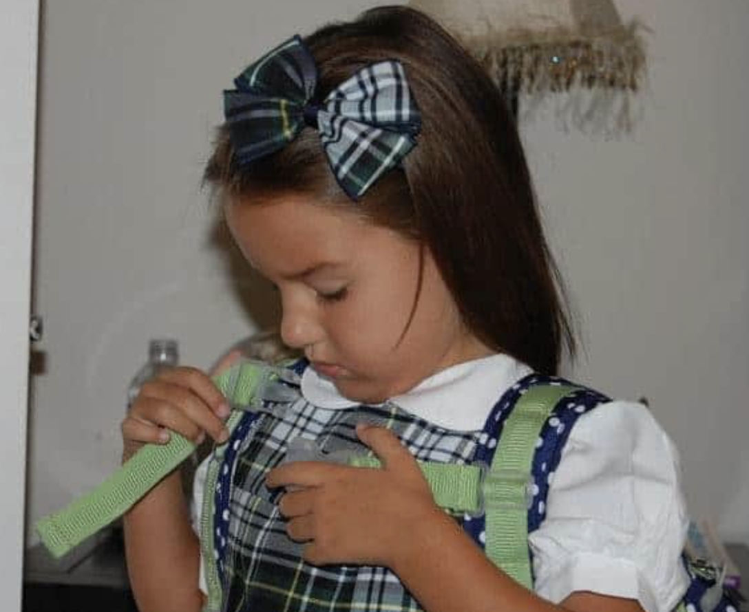 Young girl in a school uniform with a hair bow