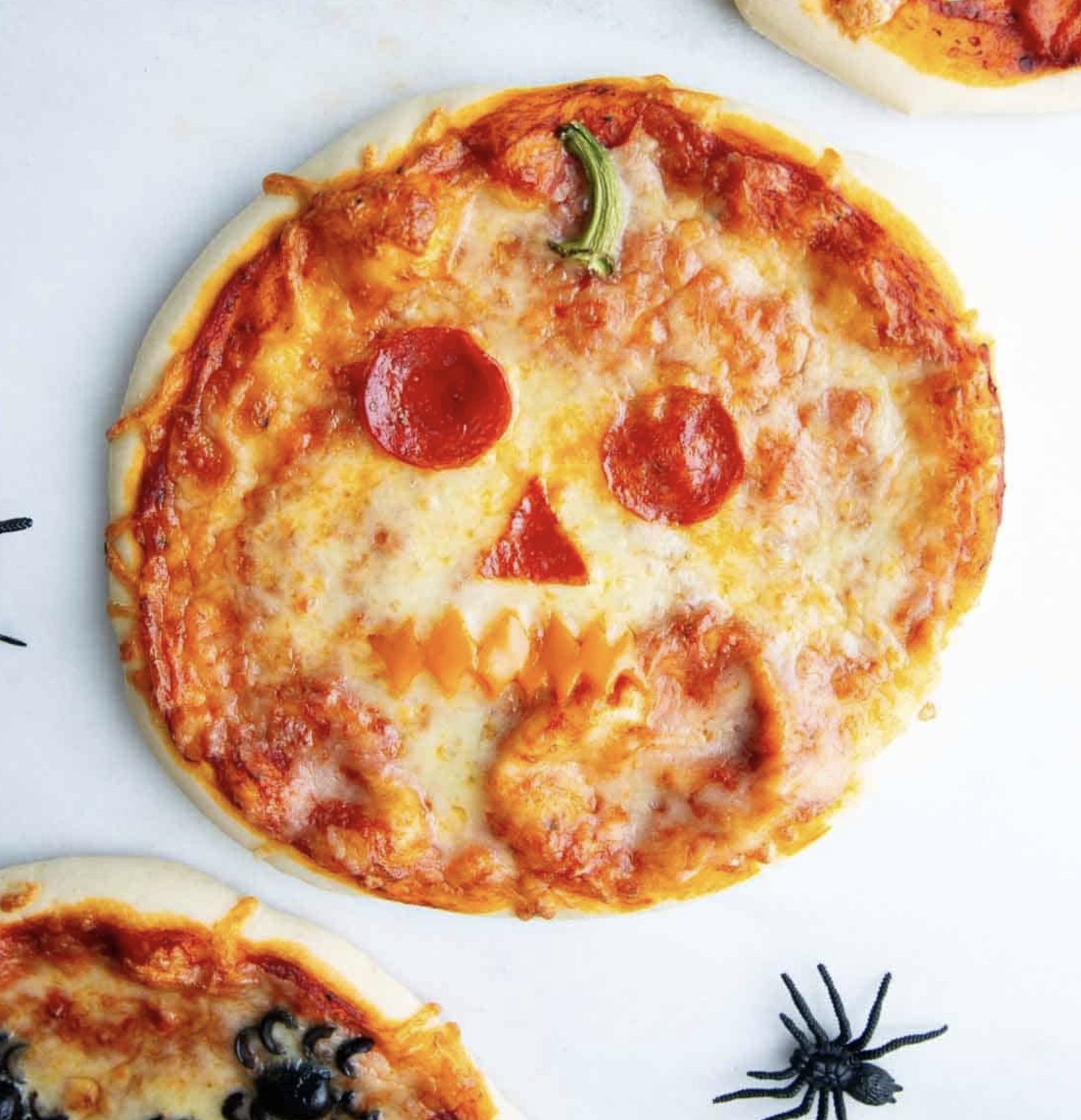 Jack-o'-lantern pizza with a pepperoni face
