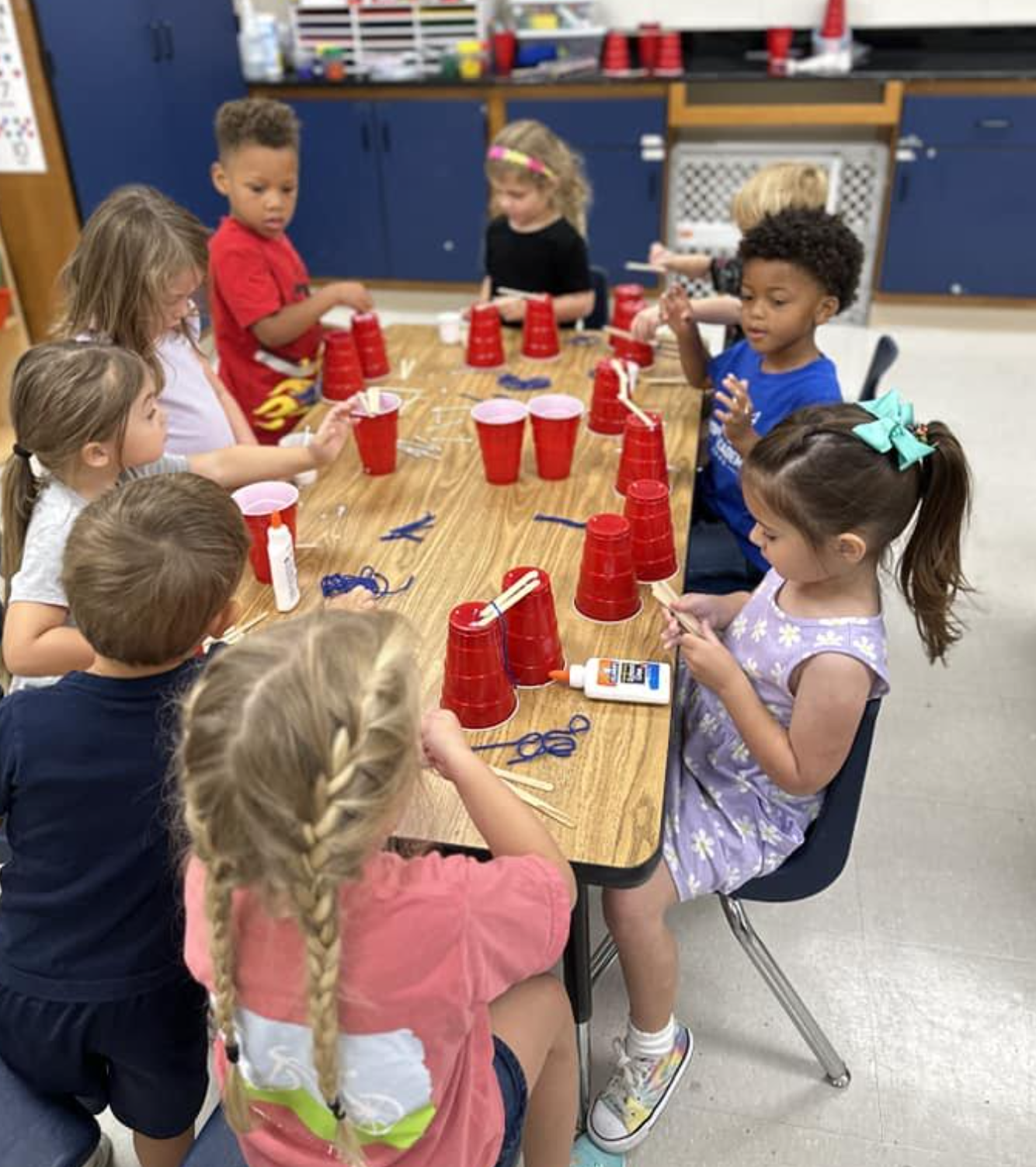 Young students doing a stacking cup activity at Hope Academy