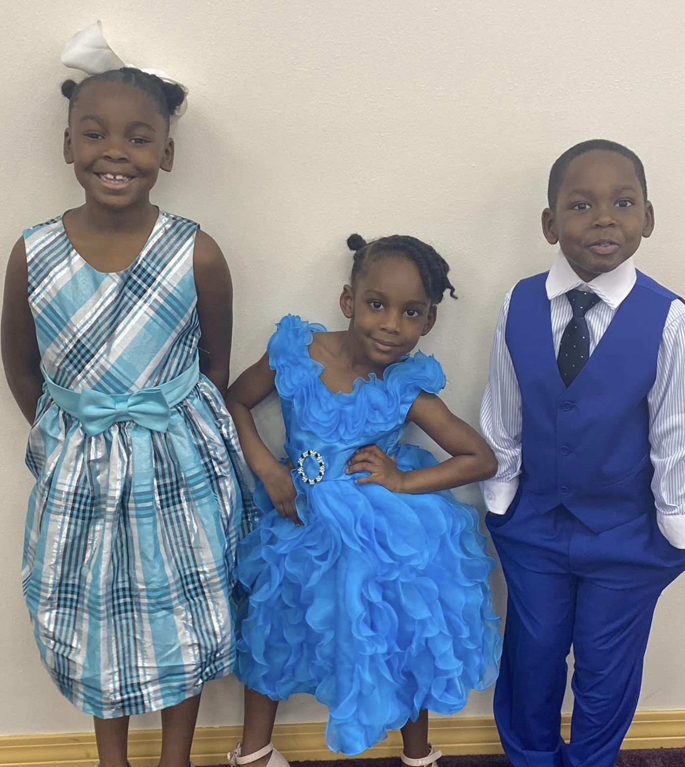 Three siblings dressed up for their adoption day