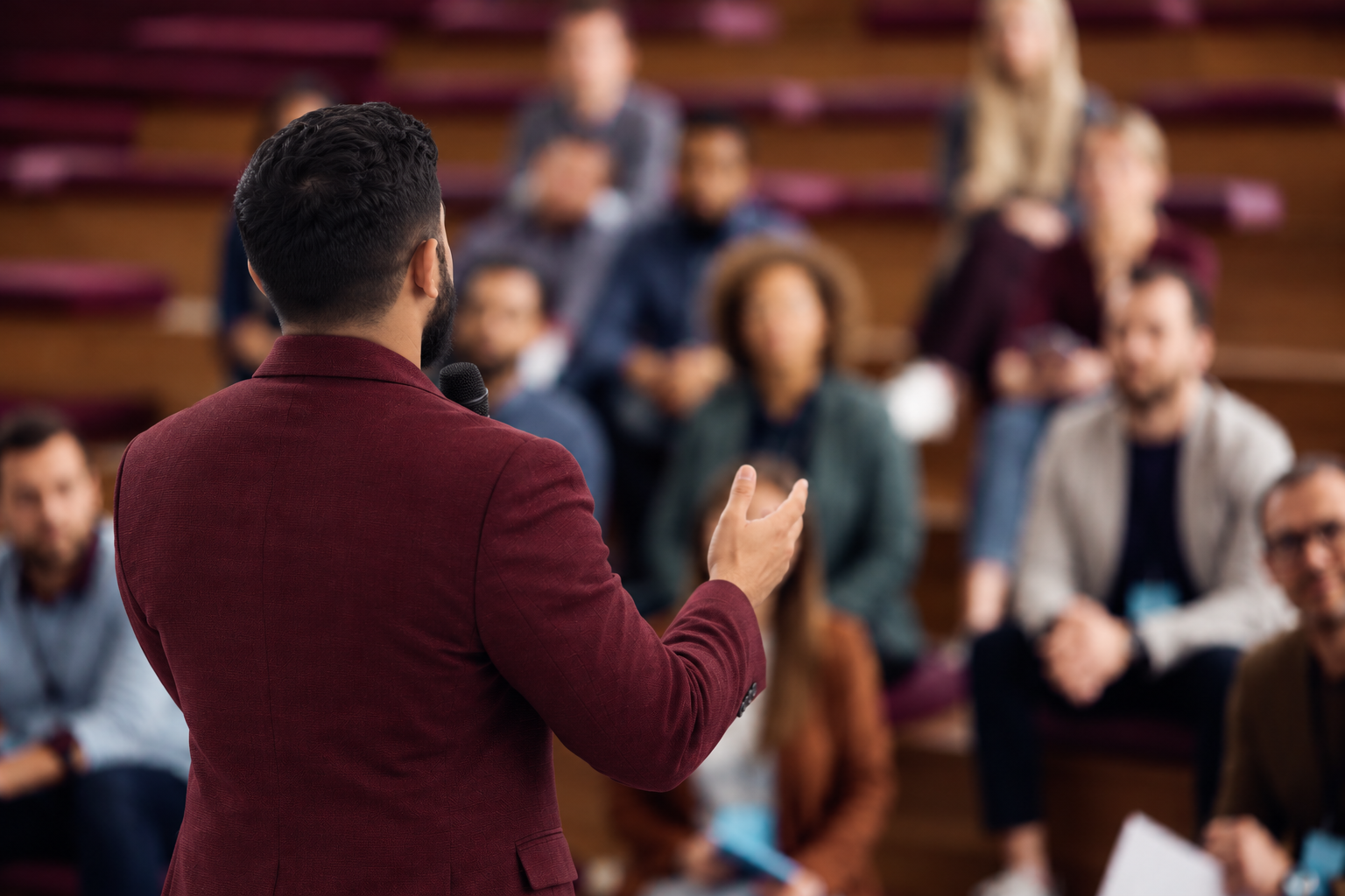 Man giving a presentation to an audience in a lecture hall.