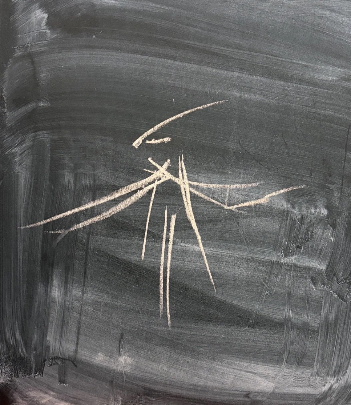 Chalk drawing of a stick figure phoenix on a blackboard