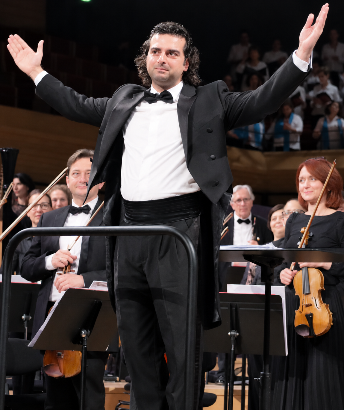 A conductor leading an orchestra during a performance.