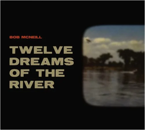 Album cover for Bob McNeill’s “Twelve Dreams of the River,” featuring bold cream text and a blurred river landscape.