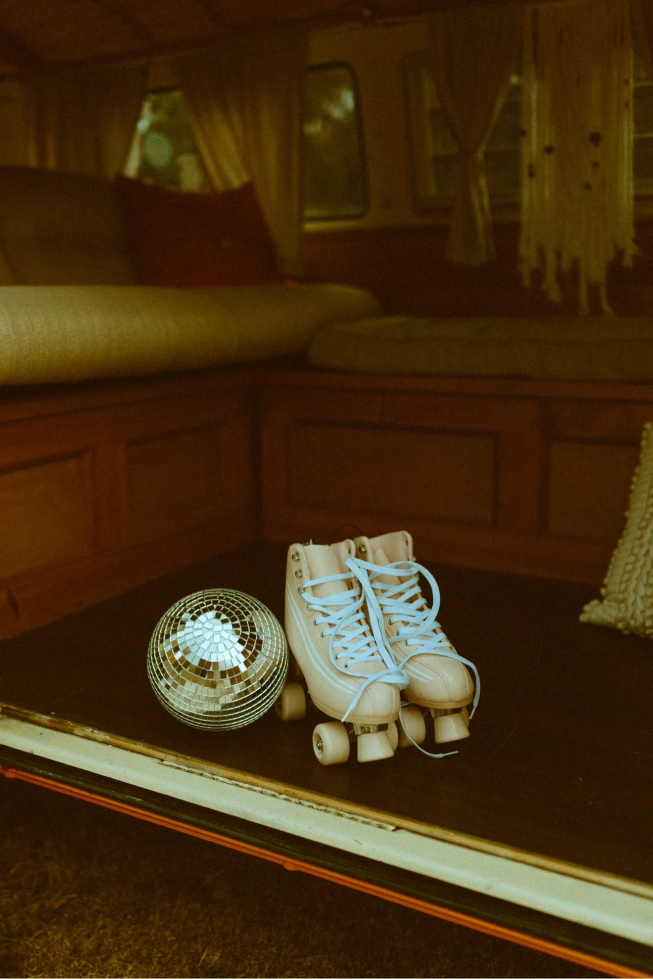 Roller skates and disco ball inside Nancy for a brand content shoot, orange VW bus