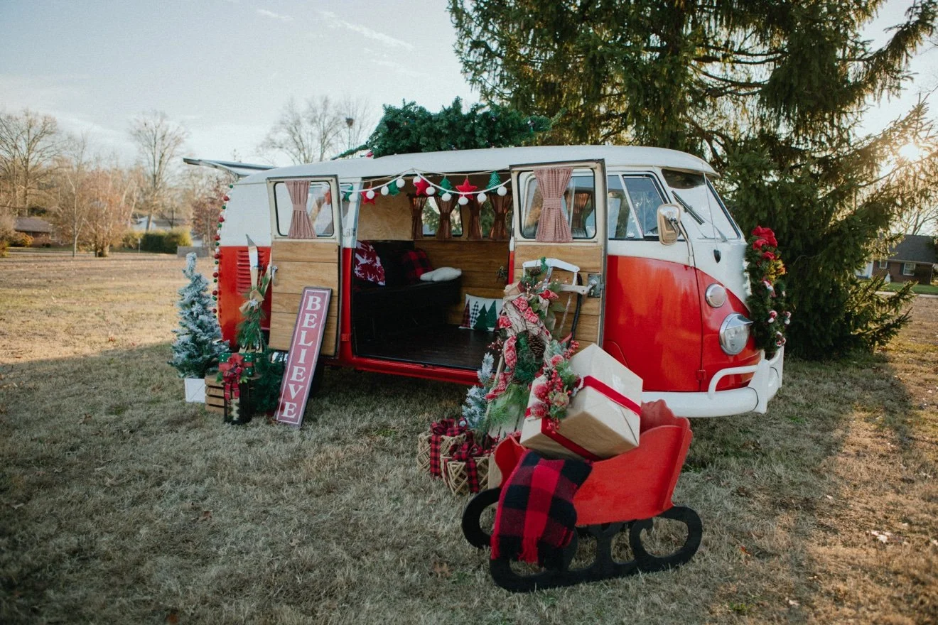 Ruby, red VW bus decorated for Christmas with Believe sign, Knoxville TN