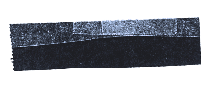 Close-up of black rectangular object with jagged edges on top and textured surface.