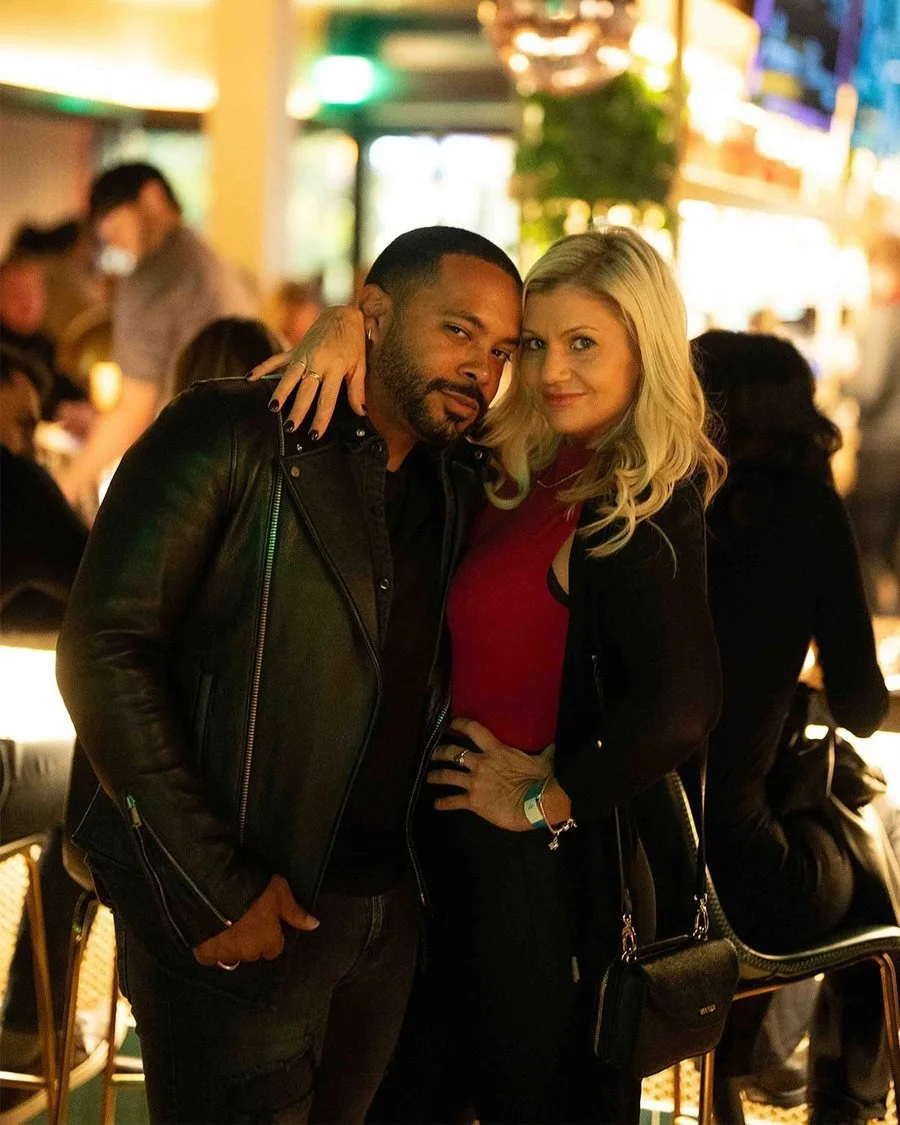 Couple posing together at a warmly lit restaurant or lounge
