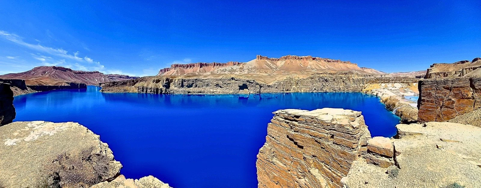 Band-e Amir’s deep blue lake surrounded by rugged ochre cliffs and mountains in Afghanistan’s Central Highlands.