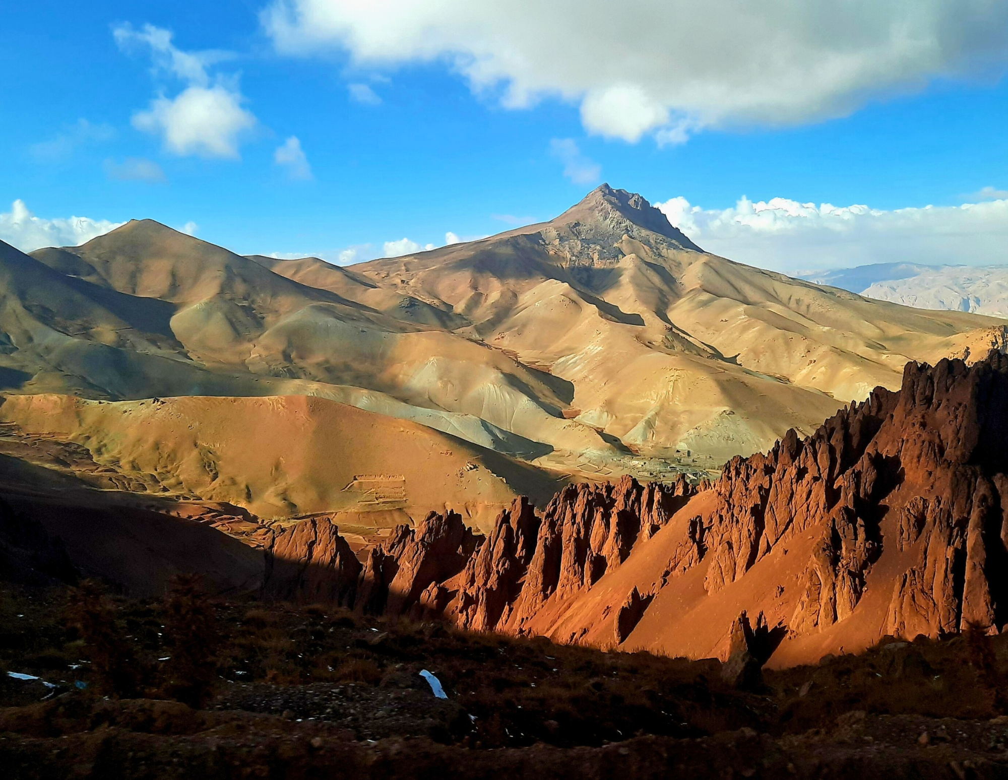 The mountains of Daikundi rise in layers of ochre, rust and muted gold, their exposed rock revealing the region’s rich geological character. Known for its mineral resources, the province holds a landscape shaped by ancient geological processes, where