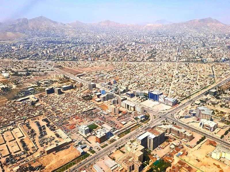Seen from the air, Kabul unfolds as a vast urban landscape surrounded by mountains. Dense neighbourhoods, major roads and expanding built-up areas reveal the scale and complexity of Afghanistan’s capital, where the city meets the rugged terrain that 