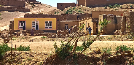 A newly built yellow house stands among village homes in Ghor, where earlier shelters were destroyed by flooding. The rebuilding of homes is more than a physical recovery; it is an essential step towards restoring security, stability and the foundati