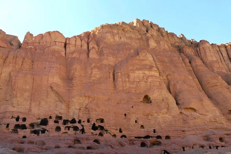 The small caves carved into the sandstone cliffs near the Buddhas of Bamyan. These historic cave dwellings and meditation spaces form part of the remarkable cultural landscape surrounding the monumental Buddha niches.