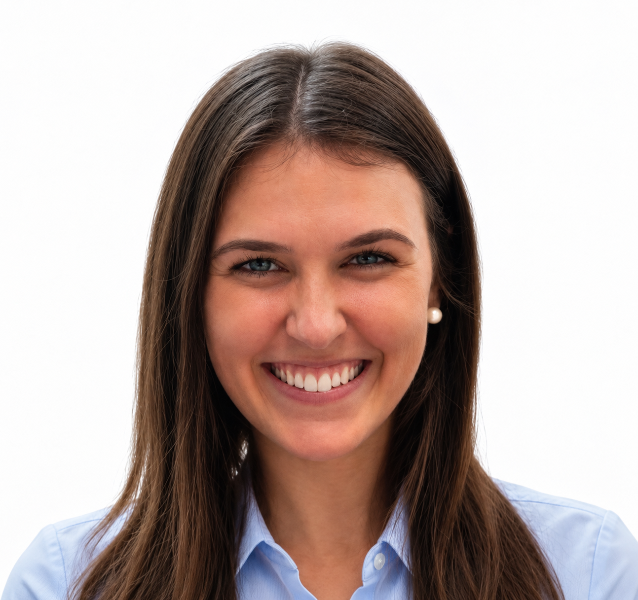 Smiling woman with long brown hair wearing a light blue collared shirt against a white background