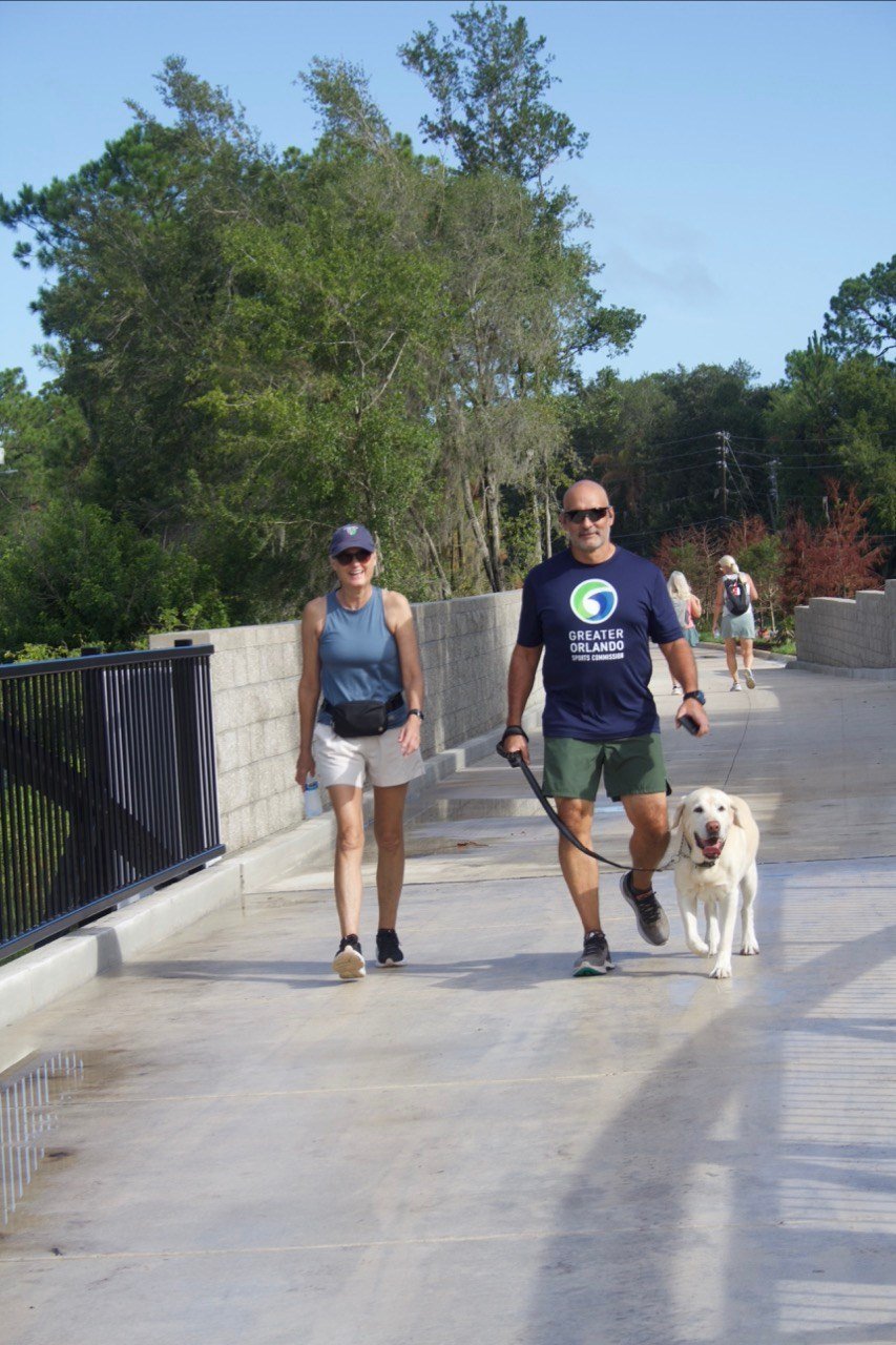 Maryann, Tony and Benny Davit walking their dog on the Ward Trail in Windermere