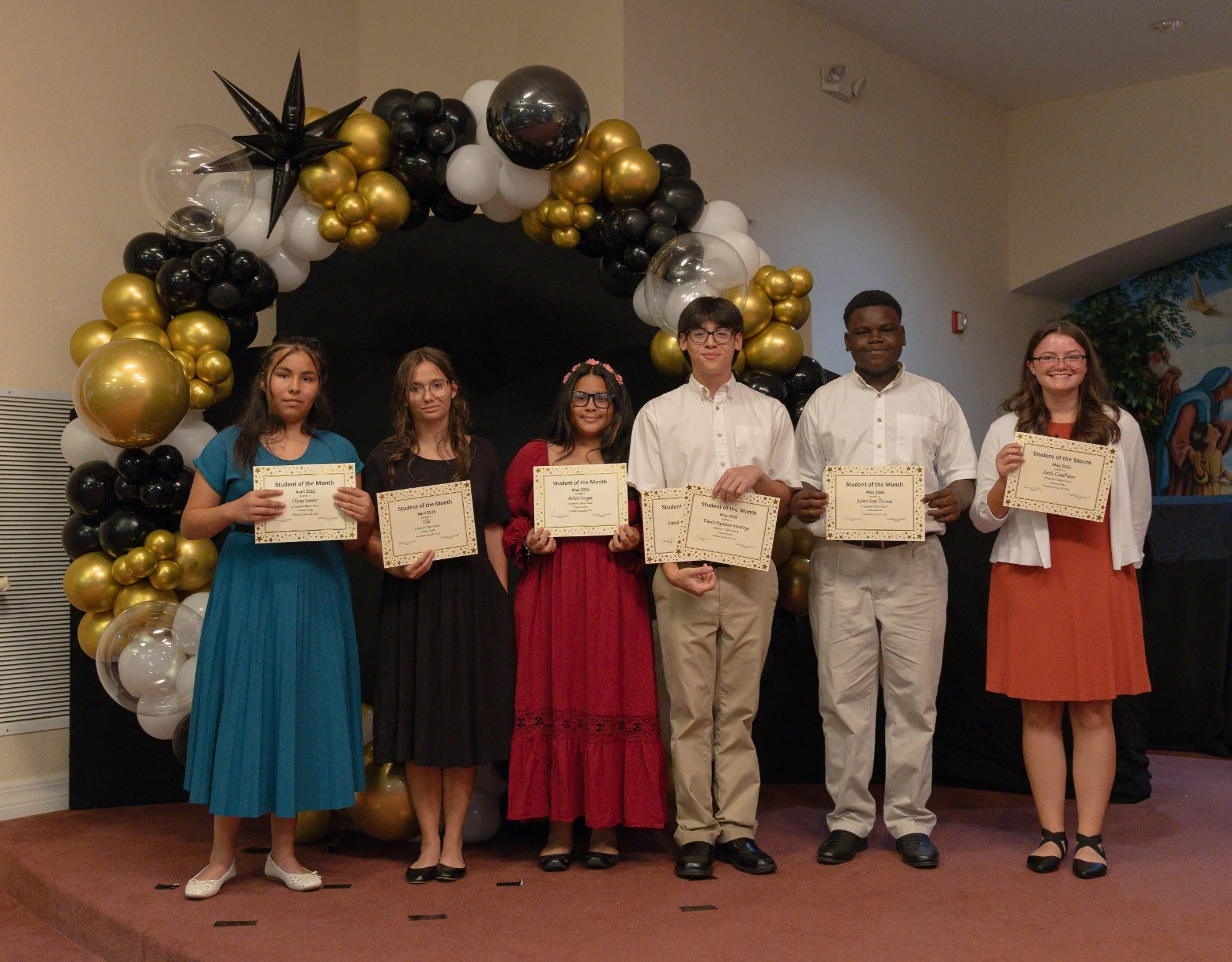 Young people from Edgewood Children's Ranch holding certificates at a celebration