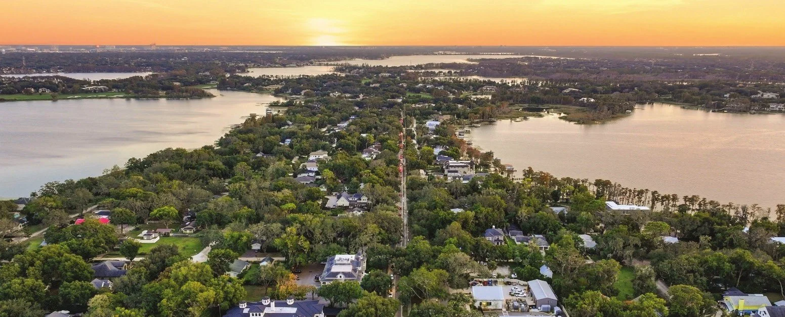 Aerial view of Windermere homes, oak canopy and the Butler Chain of Lakes at sunset