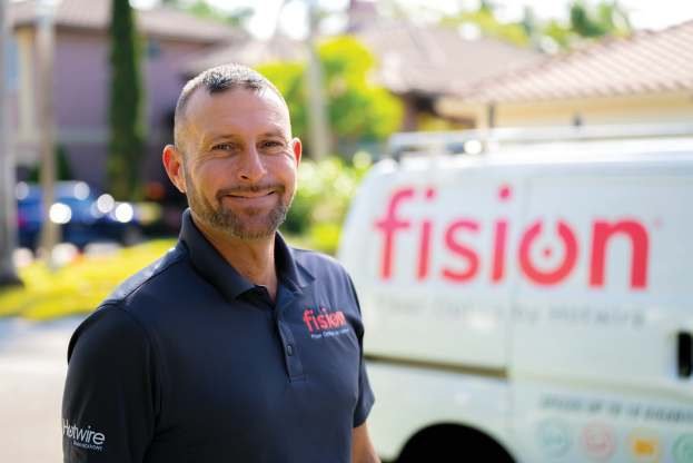 A Hotwire Communications team member with a Fision service van