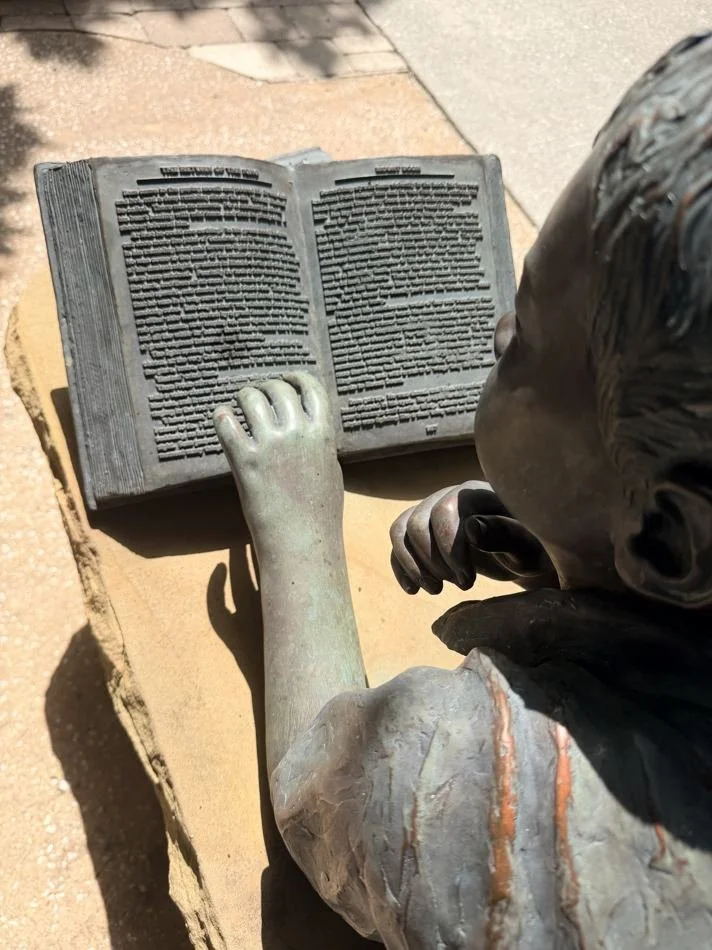 Close-up of the bronze Harry Potter pages on the Summertime Read sculpture in Windermere