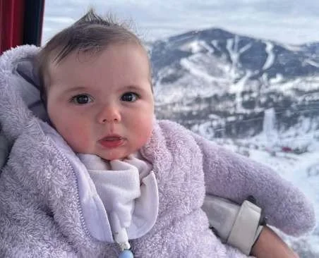 Amelia Berry as a baby with snowy mountains behind her, 2024
