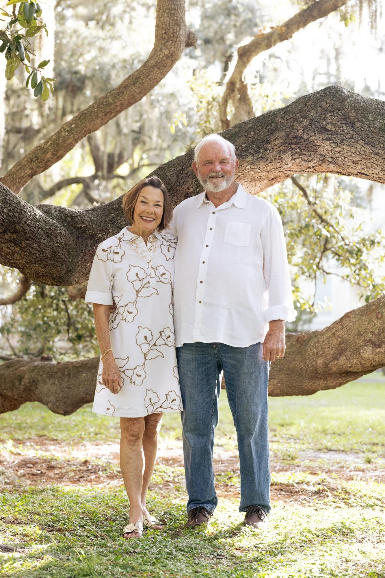 Bob and Kathy McKinley beneath a sprawling oak tree in Windermere