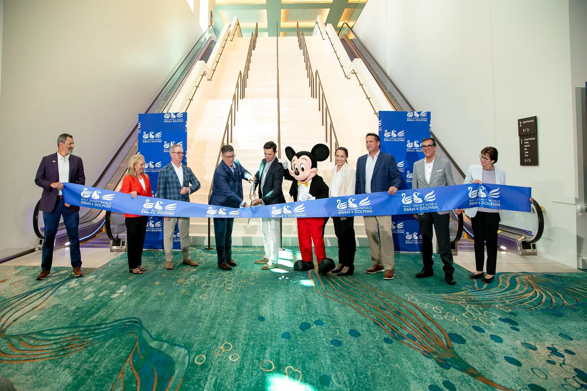 Ribbon cutting with Mickey Mouse and hotel leaders opening the new Peninsula event space at the Walt Disney World Swan and Dolphin