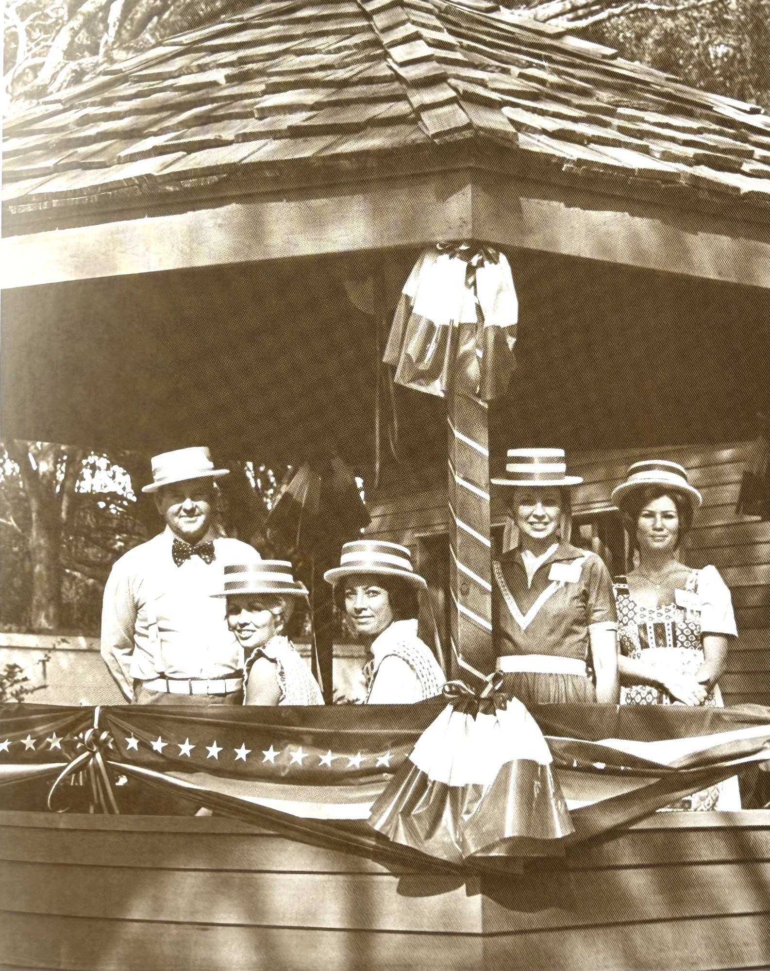 Historic sepia photo of families gathered for a celebration