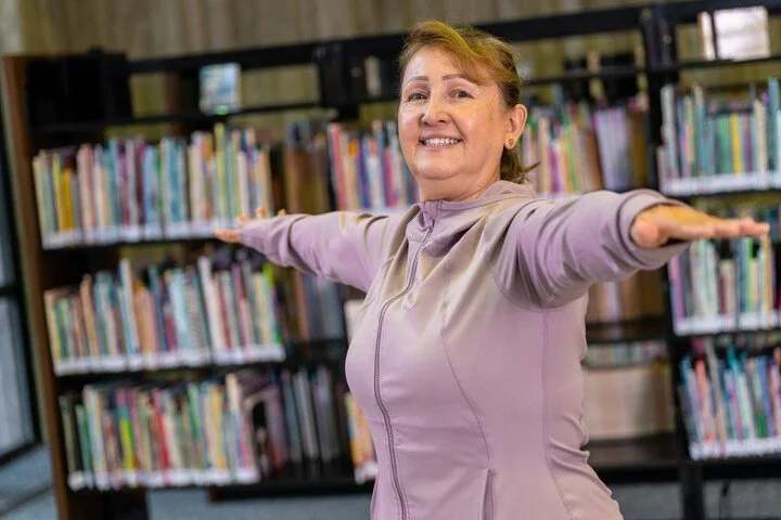 Orange County Library System staff member leading an activity among the library shelves