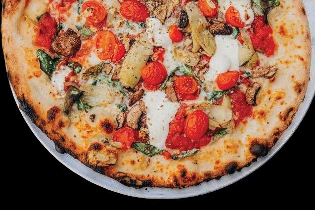 Wood-fired Neapolitan-style pizza with tomatoes, mushrooms and fresh mozzarella from V Pizza Lake Buena Vista