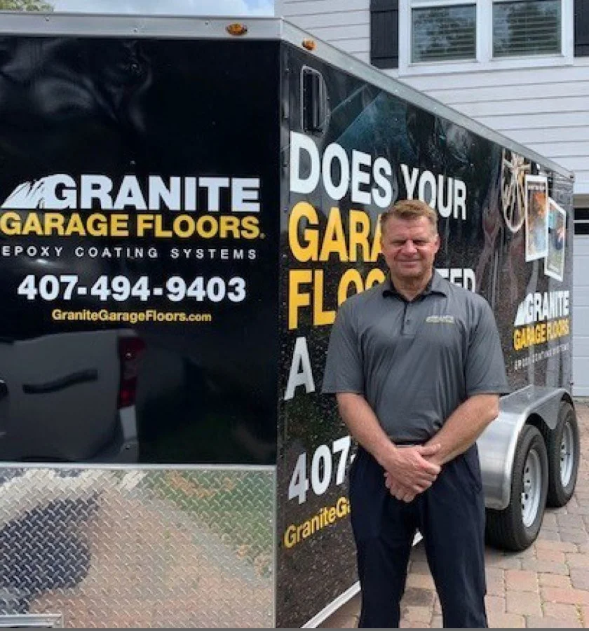 Rich Whiddon, owner of Granite Garage Floors Orlando, beside his company trailer