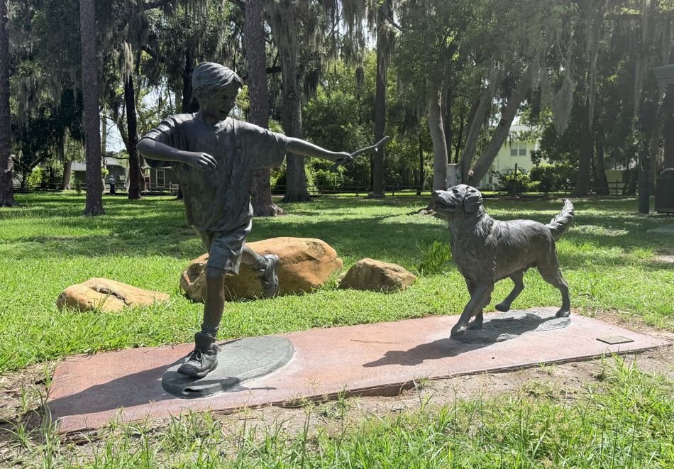 Golden Games bronze of a boy and golden retriever in Windermere Central Park