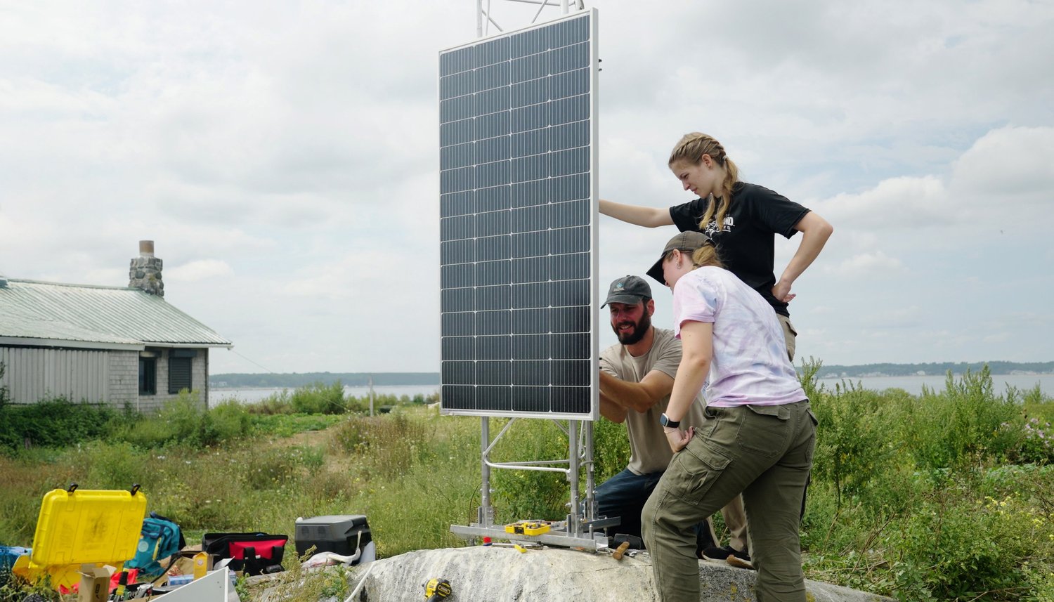 Jon Waddell shows University of New England students how the wave sensors are installed on Ram Island