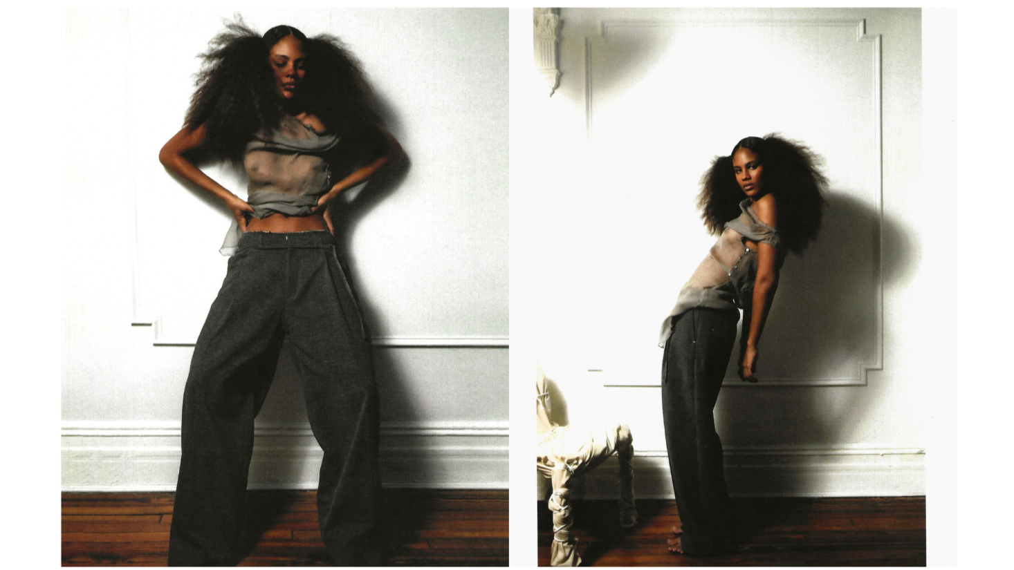 Fashion editorial showing a model with voluminous curly hair wearing a cropped gray top and wide-leg dark pants, posed against a white paneled wall in two side-by-side views.