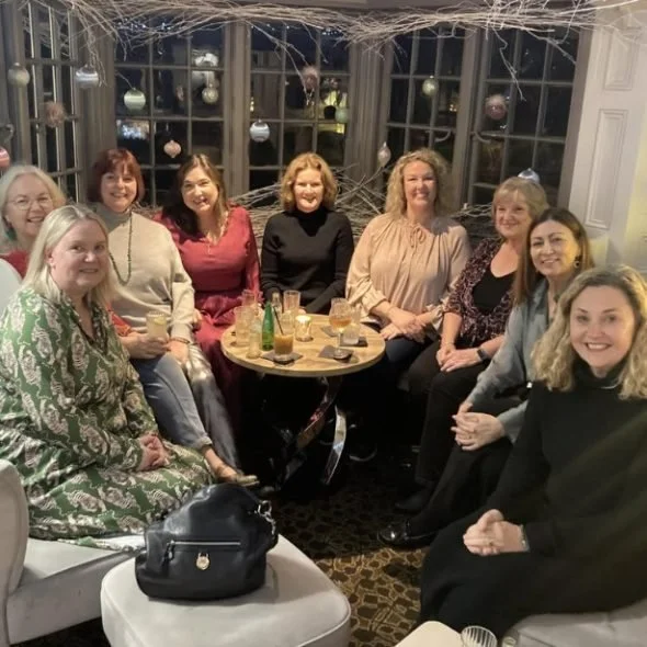 A group celebrating around a table.jpg