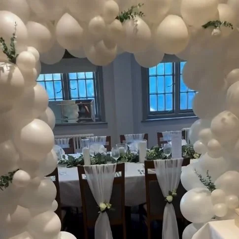 A table dressed with white balloons for a party.jpg